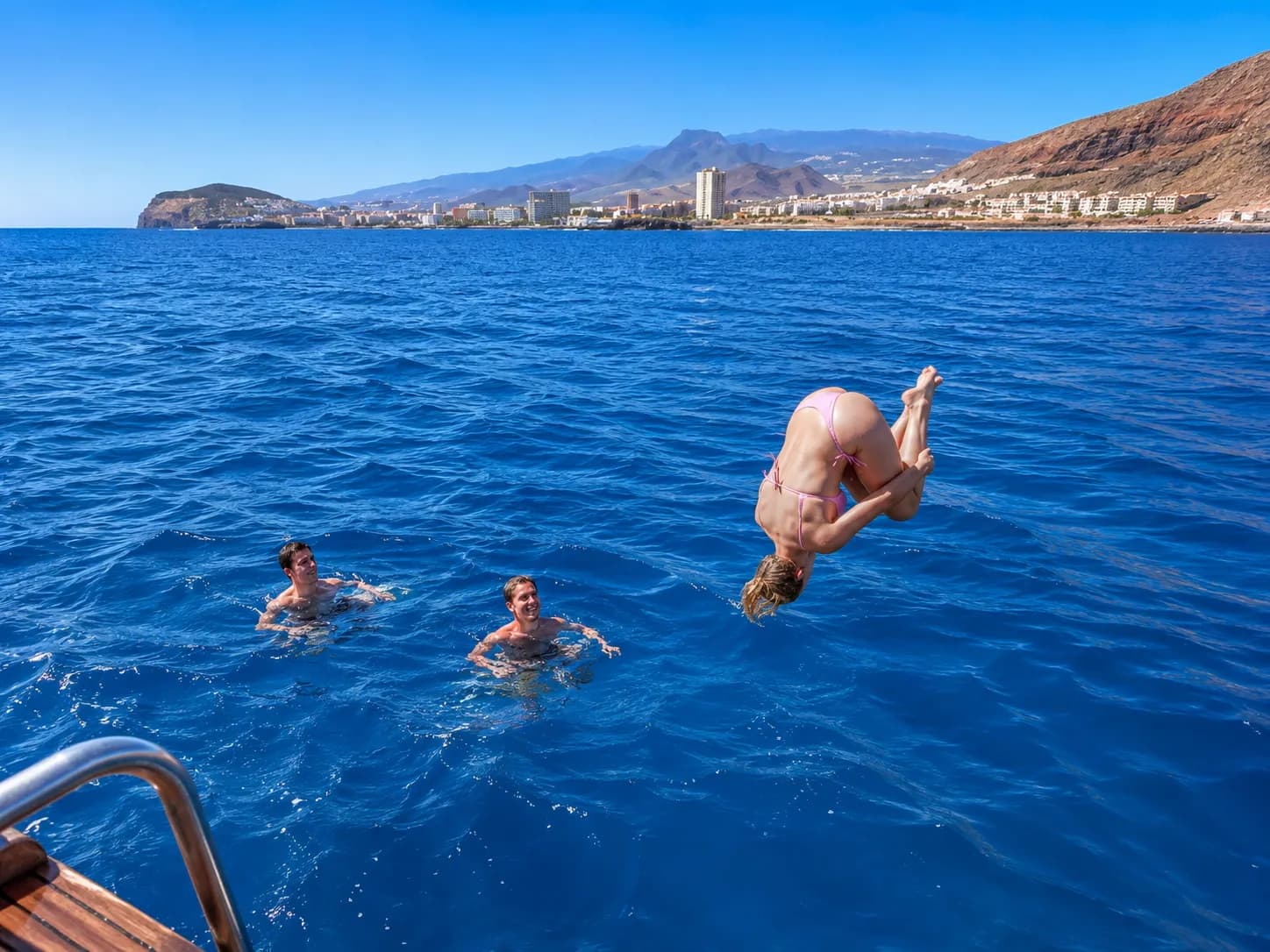 Guests jumping into the sea at the swim stop